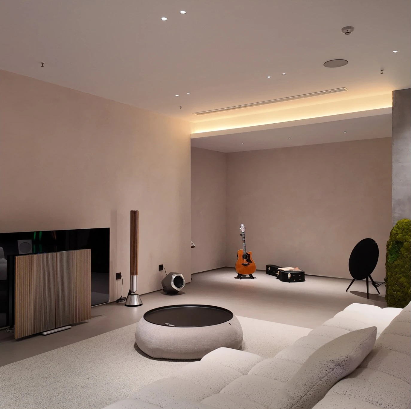 Architectural living room with warm indirect lighting and soft neutral furniture